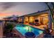 Expansive backyard showcases a sparkling pool, landscaped gardens, and comfortable patio seating for outdoor living at 2415 W Hazelhurst Ct, Anthem, AZ 85086