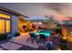 Luxurious backyard featuring a pool, lounge chairs, and a covered patio for ultimate relaxation and outdoor enjoyment at 2415 W Hazelhurst Ct, Anthem, AZ 85086