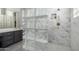 Close-up of shower featuring marble and glass block, as well as a pebble floor at 2415 W Hazelhurst Ct, Anthem, AZ 85086