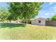 Large backyard with mature trees offering shade and privacy, enhancing the home's natural setting at 2425 E Harvard St, Phoenix, AZ 85008