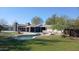 Charming backyard with a uniquely shaped pool, hot tub, and lush green lawn at 2425 E Harvard St, Phoenix, AZ 85008