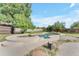Backyard pool with a surrounding stone patio, a spa, and lush landscaping for a private oasis at 2425 E Harvard St, Phoenix, AZ 85008
