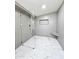 Modern tiled shower and bathroom with marble floors and triangle corner seat at 2425 E Harvard St, Phoenix, AZ 85008
