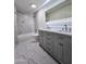 Modern bathroom with double vanity, marble tiled wall, and modern lighting at 2425 E Harvard St, Phoenix, AZ 85008
