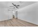 Spacious bedroom featuring sleek flooring, a ceiling fan, and a sliding barn door to the ensuite bathroom at 2425 E Harvard St, Phoenix, AZ 85008