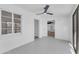 A bright bedroom features tile floors, bright lighting, and door to patio at 2425 E Harvard St, Phoenix, AZ 85008