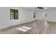 Bright bedroom with wood-look flooring, modern windows, a ceiling fan and white walls at 2425 E Harvard St, Phoenix, AZ 85008