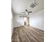 Bedroom with wood-look floors, sliding barn door to bathroom, and ceiling fan at 2425 E Harvard St, Phoenix, AZ 85008