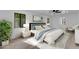 Stylized bedroom with wood-look flooring, neutral decor, and two bright windows at 2425 E Harvard St, Phoenix, AZ 85008