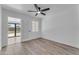 A bright bedroom featuring wood floors, bright lighting, and door to patio at 2425 E Harvard St, Phoenix, AZ 85008