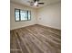 Bedroom with natural light showcasing wood-look floors and fresh white walls at 2425 E Harvard St, Phoenix, AZ 85008