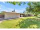 One-story stucco home with a well-manicured lawn and mature trees, showcasing its curb appeal at 2425 E Harvard St, Phoenix, AZ 85008