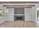 Fireplace featuring a brick hearth and built-in shelving in a neutrally decorated living room at 2425 E Harvard St, Phoenix, AZ 85008