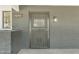 Charming front door featuring stylish gray brick and an ornate security screen, welcoming visitors at 2425 E Harvard St, Phoenix, AZ 85008