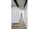 Hallway with wood flooring and white walls leads to various rooms in the modern home at 2425 E Harvard St, Phoenix, AZ 85008