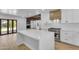 Bright kitchen featuring an island, modern stainless steel appliances, and wood beam accents at 2425 E Harvard St, Phoenix, AZ 85008