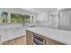 Modern kitchen featuring a quartz island, stainless appliances, white cabinets, and a large picture window at 2425 E Harvard St, Phoenix, AZ 85008