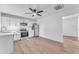 Modern kitchen with white cabinetry, stainless steel appliances and wood-look vinyl flooring at 2425 E Harvard St, Phoenix, AZ 85008