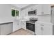 Bright kitchen featuring white cabinets, stainless steel appliances, and quartz countertops at 2425 E Harvard St, Phoenix, AZ 85008
