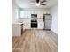 Bright kitchen with white cabinets, stainless steel appliances and wood-look floors at 2425 E Harvard St, Phoenix, AZ 85008