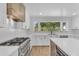 Modern kitchen boasts white cabinets, stainless appliances, and an island with seating at 2425 E Harvard St, Phoenix, AZ 85008