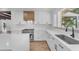 Kitchen featuring stainless steel appliances, white cabinets, and view to outdoors at 2425 E Harvard St, Phoenix, AZ 85008