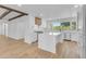 Modern kitchen with white cabinetry, an island, stainless steel appliances, and wood beam accents at 2425 E Harvard St, Phoenix, AZ 85008