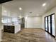 Open-concept home with stainless steel appliances, modern kitchen island, and wood flooring at 2425 E Harvard St, Phoenix, AZ 85008