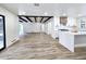 Modern living room showcasing wood floors, black beams, white walls and an open kitchen design at 2425 E Harvard St, Phoenix, AZ 85008