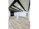 Spacious living room with wood floors, black beams, white walls, recessed lighting, and built-in shelving at 2425 E Harvard St, Phoenix, AZ 85008