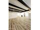 Bright living room showcases wood floors, white walls, black beams and modern recessed lighting at 2425 E Harvard St, Phoenix, AZ 85008