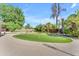 Expansive backyard showcasing a well-kept putting green, mature trees, and lush landscaping for a serene escape at 2425 E Harvard St, Phoenix, AZ 85008