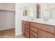 Bathroom featuring double sinks with wood cabinets at 25215 N 131St Dr, Peoria, AZ 85383