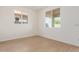 Well-lit bedroom with wood-look tile flooring and a large window offering natural light at 25215 N 131St Dr, Peoria, AZ 85383
