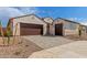 Charming home featuring a well-manicured yard, brick driveway, and three-car garage at 25215 N 131St Dr, Peoria, AZ 85383
