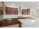 Modern kitchen featuring stainless steel appliances and a center island with white countertop at 25215 N 131St Dr, Peoria, AZ 85383