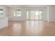 Bright living room with wood-look tile floors and sliding glass doors to the backyard at 25215 N 131St Dr, Peoria, AZ 85383