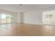 Spacious living room featuring wood-look tile floors and a large sliding glass door at 25215 N 131St Dr, Peoria, AZ 85383
