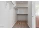 Spacious walk-in closet with shelving, racks, and neutral carpet flooring, providing ample storage at 25215 N 131St Dr, Peoria, AZ 85383