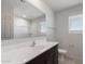 Bright bathroom featuring a long mirror, vanity, and white tub and shower at 25248 W Chanute Pass, Buckeye, AZ 85326