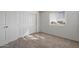 This pleasant bedroom has neutral carpeting, a window and a closet providing a versatile and comforting space at 25248 W Chanute Pass, Buckeye, AZ 85326