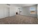 Spacious bedroom with plush carpeting, dual windows for natural light, and an en-suite bathroom for added convenience at 25248 W Chanute Pass, Buckeye, AZ 85326