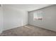 Bright bedroom with neutral carpet, a window, and a minimalist design, providing a peaceful and adaptable space at 25248 W Chanute Pass, Buckeye, AZ 85326