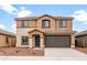 Charming two-story home with neutral stucco, tile roof, well-kept landscaping, and an attached two-car garage at 25248 W Chanute Pass, Buckeye, AZ 85326