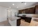 Well-lit kitchen with stainless steel appliances, granite countertops, and an island for meal preparation at 25248 W Chanute Pass, Buckeye, AZ 85326