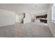 Open-concept living room boasts tile floors and seamlessly connects to the kitchen, creating a modern and spacious atmosphere at 25248 W Chanute Pass, Buckeye, AZ 85326