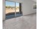 Bright living area featuring tile floors and sliding glass doors to access outdoor space at 25248 W Chanute Pass, Buckeye, AZ 85326