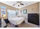 Comfortable bedroom with carpet flooring, ceiling fan, ensuite bathroom, and natural light at 2727 S Equestrian Dr # 103, Gilbert, AZ 85295