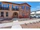 Beautiful townhome with a stone facade, inviting balcony, and cozy patio area for relaxing or entertaining guests at 2727 S Equestrian Dr # 103, Gilbert, AZ 85295