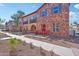 Charming townhome featuring stone accents and a cozy patio with red seating, perfect for outdoor relaxation at 2727 S Equestrian Dr # 103, Gilbert, AZ 85295